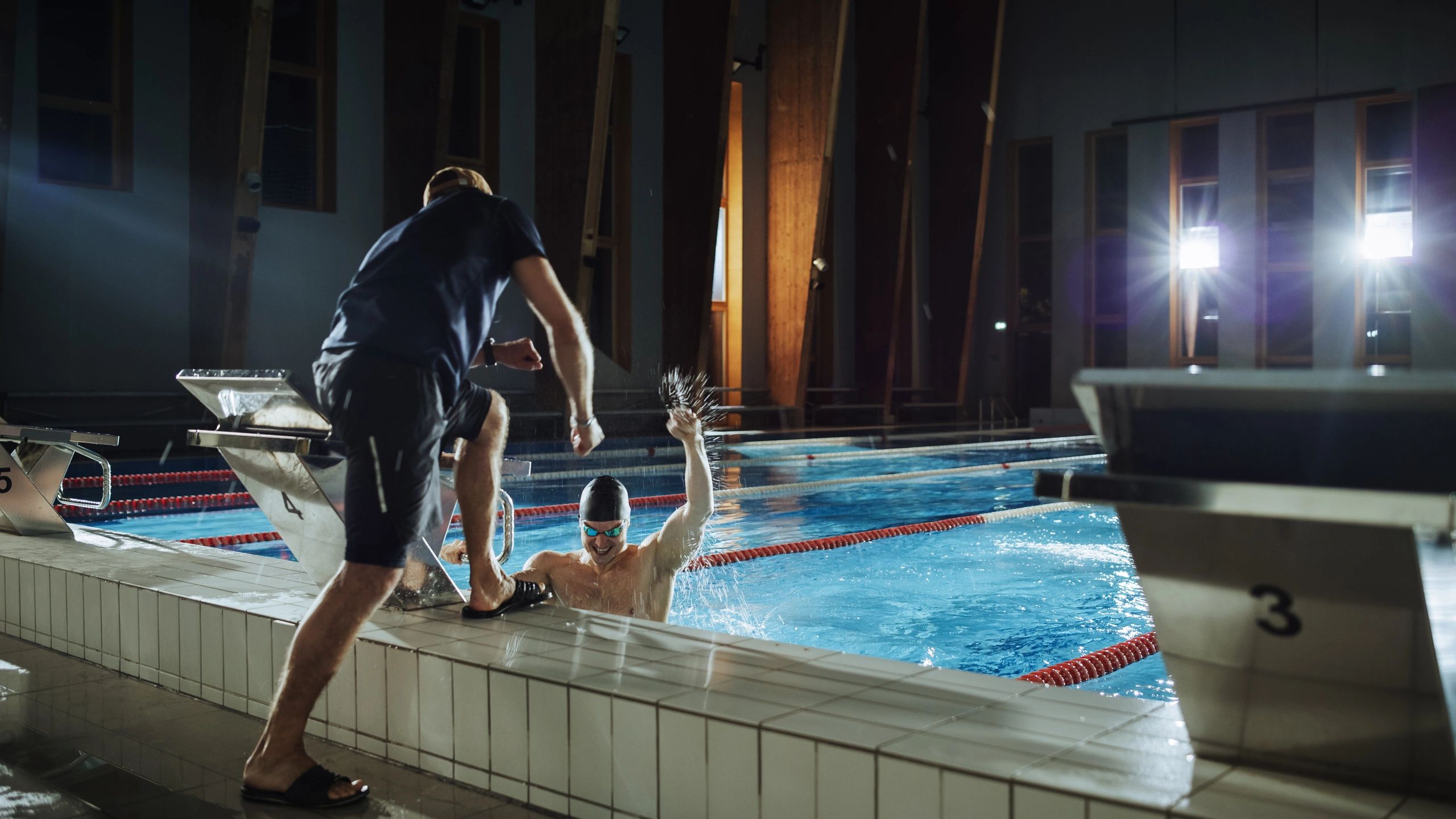 Coach and athlete during swim training at the pool